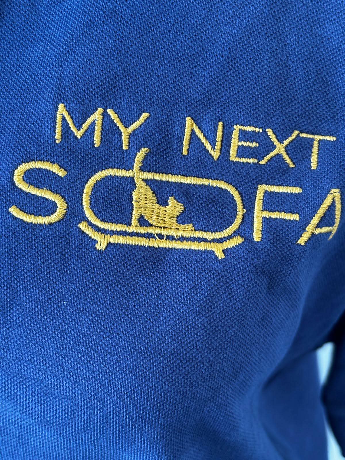Close-up of embroidered logo on blue polo shirt